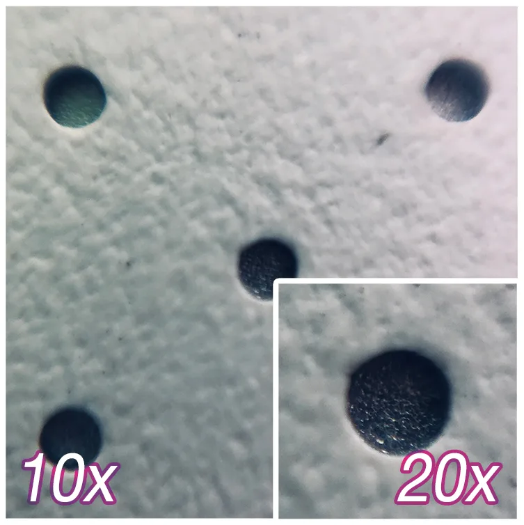 Close-up of a pin-hole perforated projection screen surface